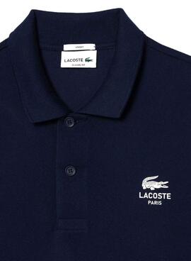 Polo Lacoste L.12.12 mit marineblauem Logo-Druck für Herren und Damen.